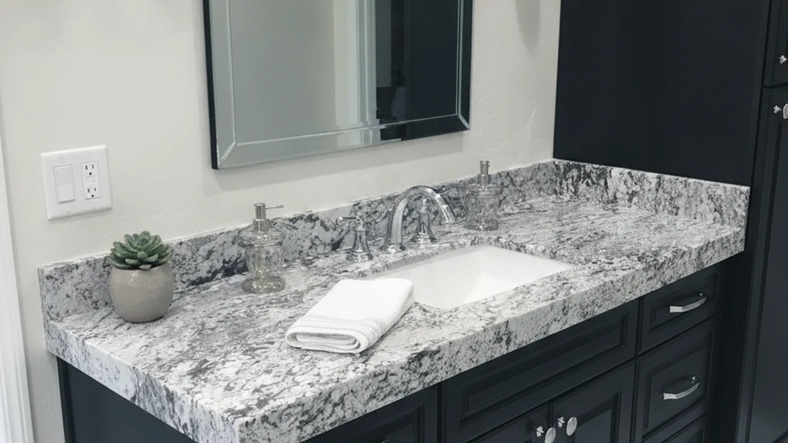 Bathroom vanity with a stone top and undermount sink, photographed in soft daylight